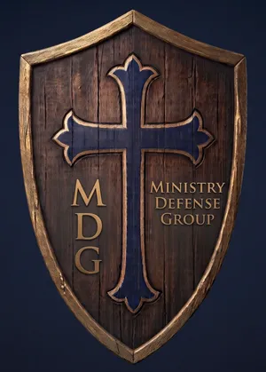 Ministry Defense Group logo: a wooden shield bearing a navy cross
